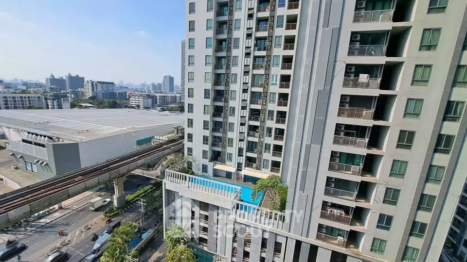 High-rise building with city view and pool, showcasing urban living in a modern apartment complex.