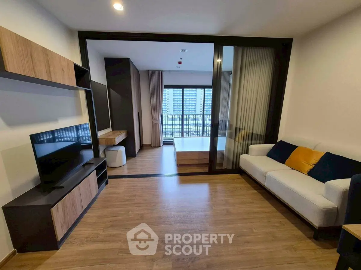 Modern living room with sleek design and city view balcony