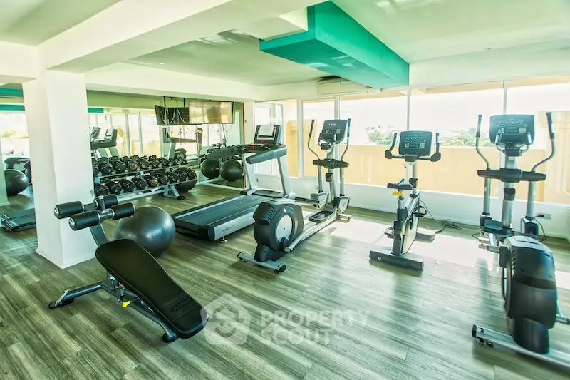 Modern gym with state-of-the-art equipment and bright natural lighting.