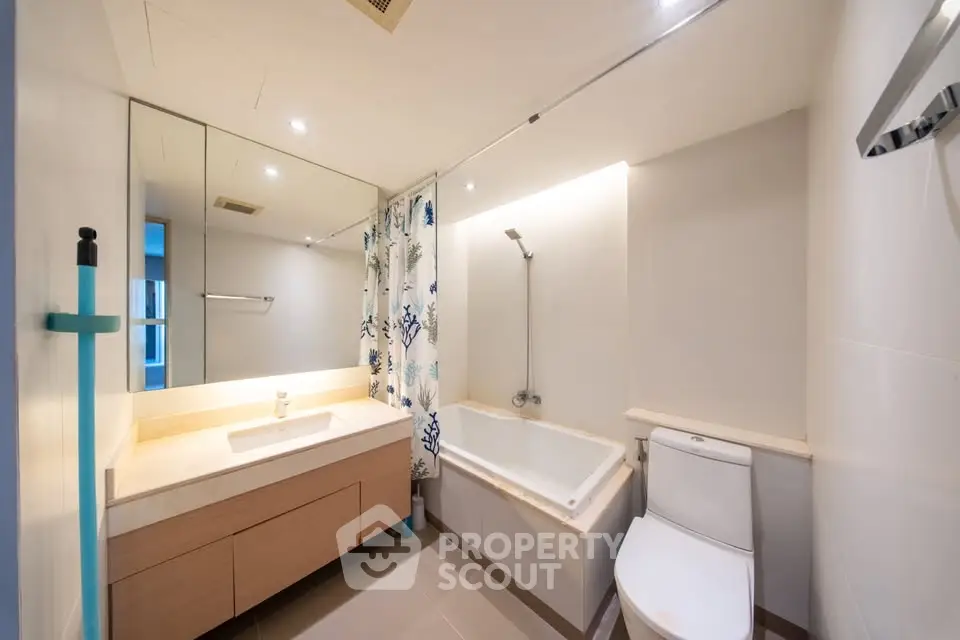 Modern bathroom with bathtub and stylish fixtures in a contemporary apartment.
