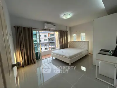 Spacious bedroom with balcony in modern apartment