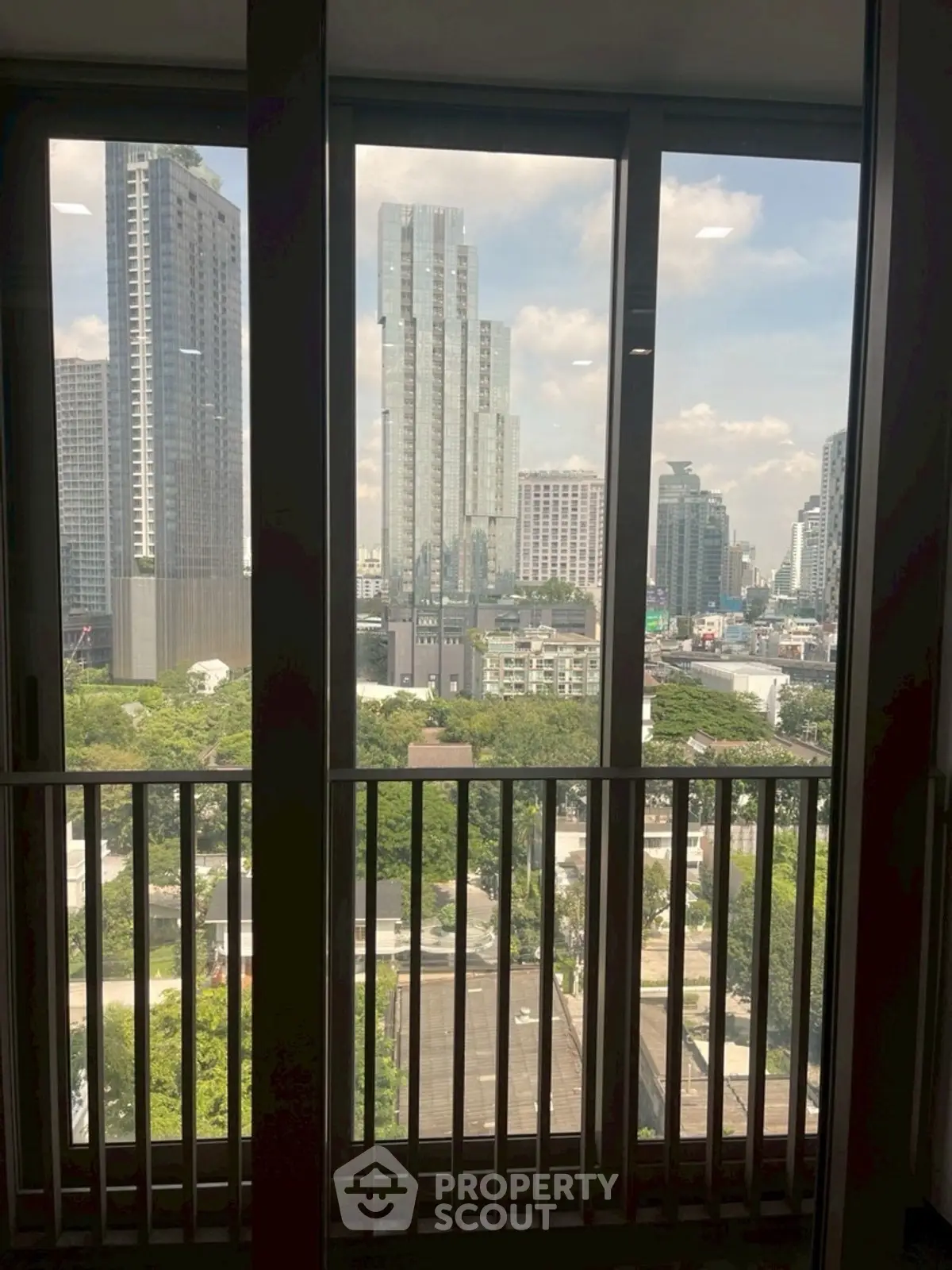 Stunning cityscape view from high-rise balcony with modern skyscrapers.