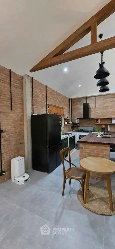 Charming rustic kitchen with brick walls and modern appliances, featuring a cozy dining area.