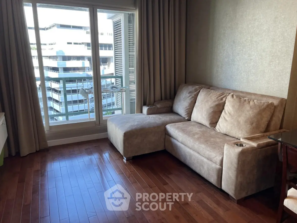 Modern living room with plush sofa and city view from large window, perfect for urban living.