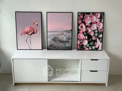 Stylish modern living room with elegant white console and artistic wall decor.