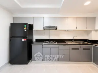 Modern kitchen with sleek cabinetry and gas stove in a contemporary apartment.