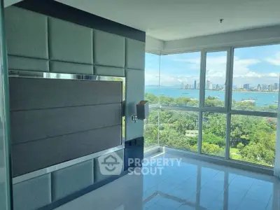 Luxurious corner unit with panoramic ocean and city views, featuring floor-to-ceiling windows and modern design.