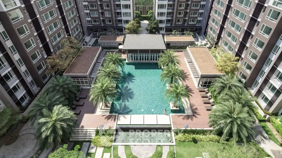 Luxurious condominium with stunning pool and lush landscaping, perfect for modern living.