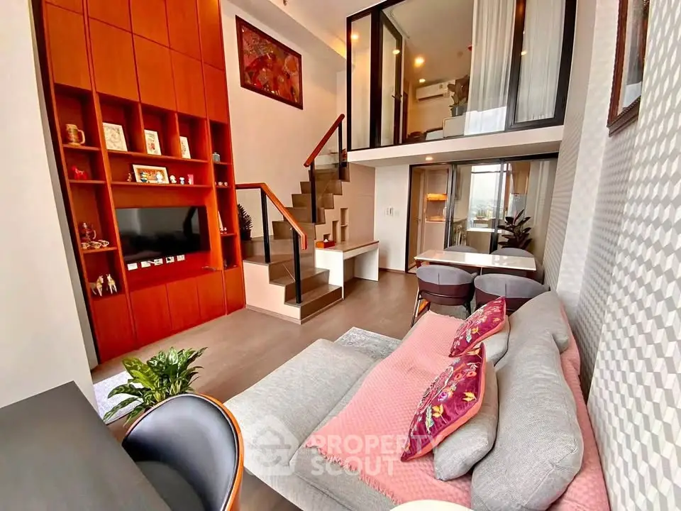 Modern duplex living room with stylish decor and mezzanine bedroom