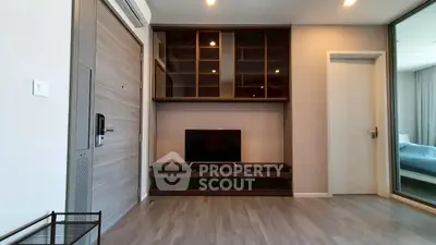 Modern living room with sleek wooden flooring and built-in TV unit