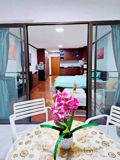 Charming studio apartment with open layout, featuring a cozy living area and modern kitchen, perfect for urban living.