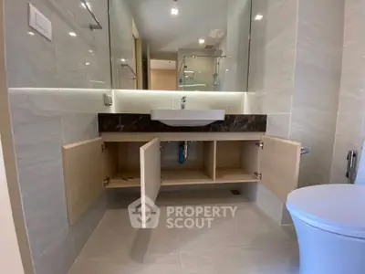Modern bathroom with open storage cabinets and sleek fixtures