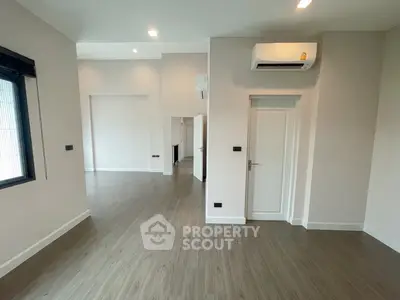 Spacious modern living room with sleek flooring and air conditioning