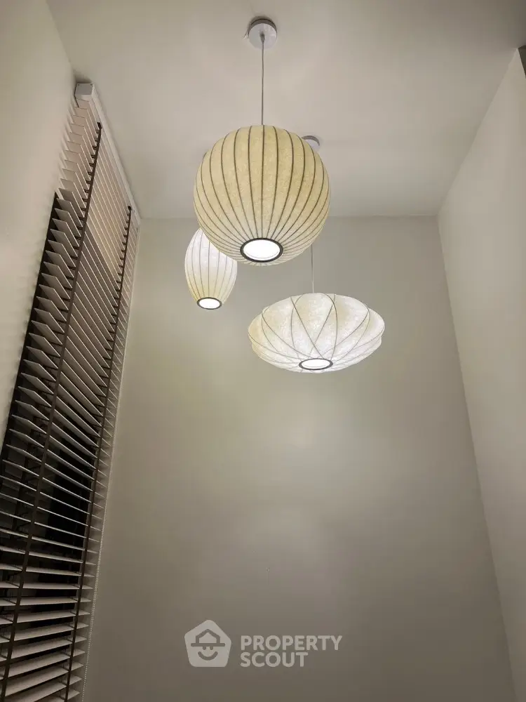 Modern interior with stylish pendant lights and window blinds