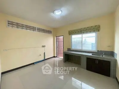 Spacious kitchen with modern sink and ample natural light