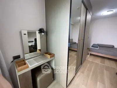 Modern bedroom with sleek wardrobe and stylish vanity area