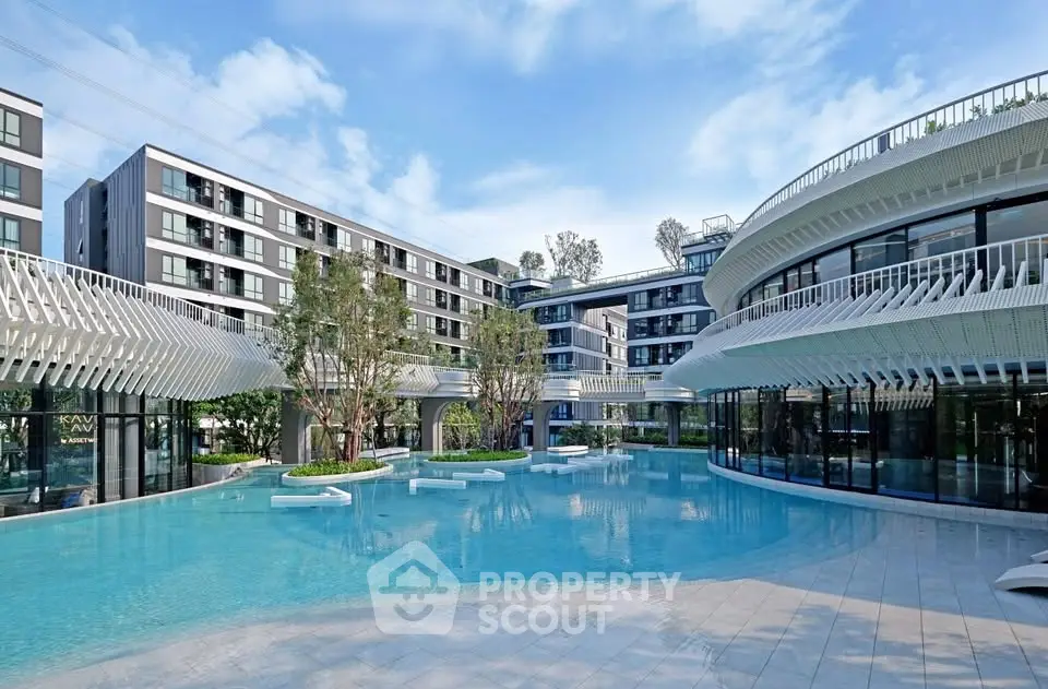 Modern residential complex with stunning pool and contemporary architecture.