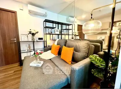 Stylish living room with modern sofa, vibrant cushions, and elegant decor in a cozy apartment.