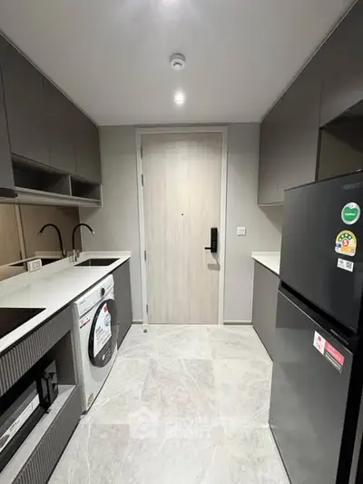 Modern kitchen with sleek appliances and minimalist design in a contemporary apartment.