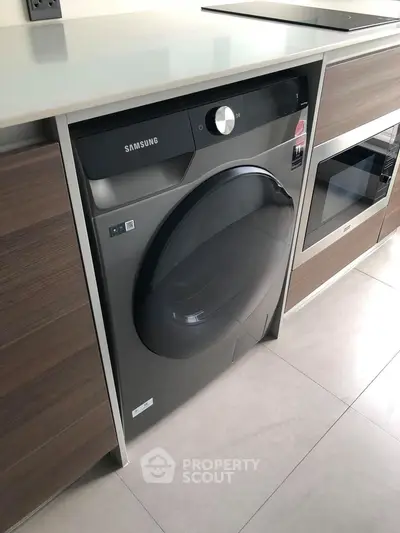 Modern kitchen with built-in Samsung washing machine and sleek cabinetry