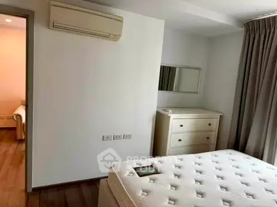Spacious bedroom with air conditioning and modern furnishings in a stylish apartment.
