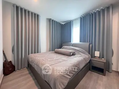 Cozy bedroom with modern decor and natural light, featuring a comfortable bed and stylish curtains.