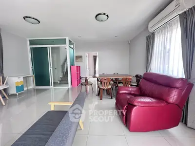Spacious living room with modern furniture and ample natural light.