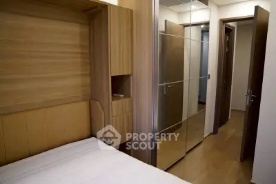 Modern bedroom with wooden accents and mirrored wardrobe doors