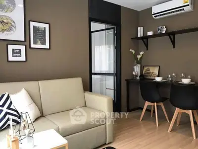 Modern living room with beige sofa, wall art, and dining area in stylish apartment.