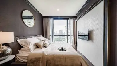 Luxurious bedroom with city view, elegant decor, and modern amenities.