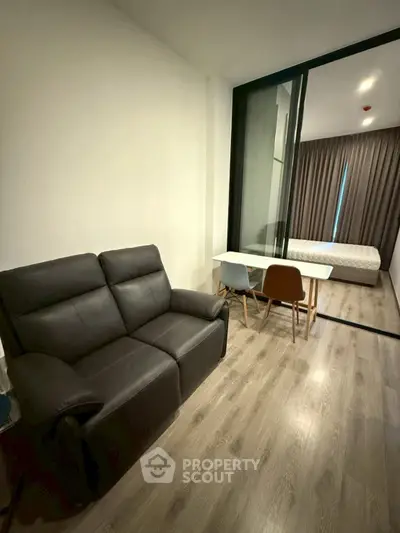 Modern studio apartment with sleek furniture and wooden flooring