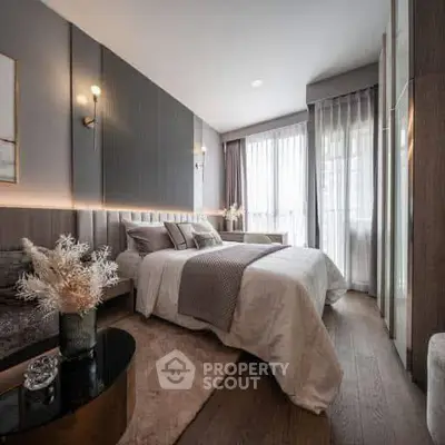 Luxurious bedroom with elegant decor and large windows offering natural light