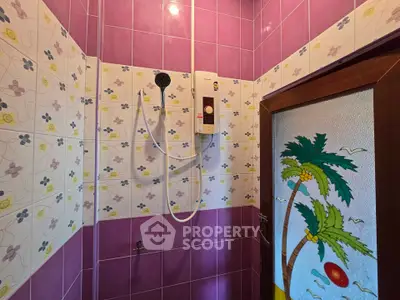 Vibrant bathroom with colorful tiles and modern shower unit