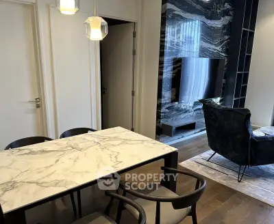 Modern living room with marble dining table and sleek TV setup