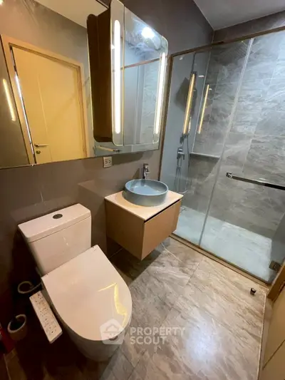 Modern bathroom with sleek fixtures and glass shower enclosure