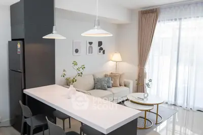Modern living room with sleek kitchen island and cozy seating area, perfect for stylish urban living.