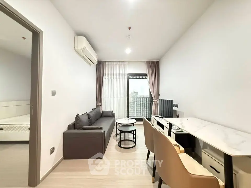 Modern living room with sleek furniture and city view, perfect for urban living.