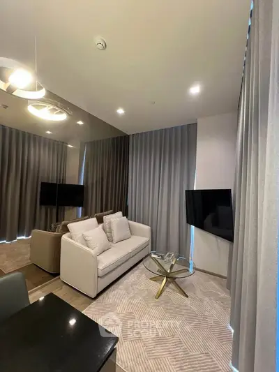 Modern living room with sleek design, featuring a cozy sofa, stylish coffee table, and wall-mounted TV.