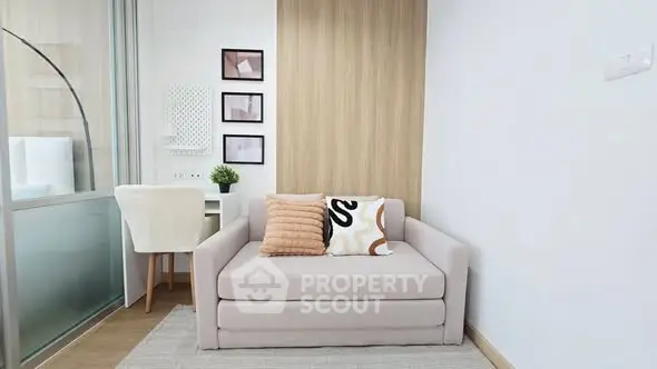 Modern living room with stylish sofa and workspace in bright apartment.