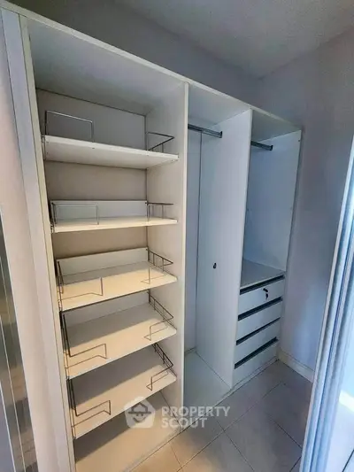 Spacious walk-in closet with ample shelving and hanging space in modern home.
