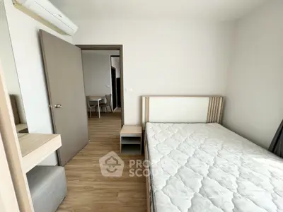 Modern minimalist bedroom with wooden flooring and neutral tones