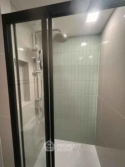 Modern bathroom shower with sleek glass doors and contemporary fixtures.