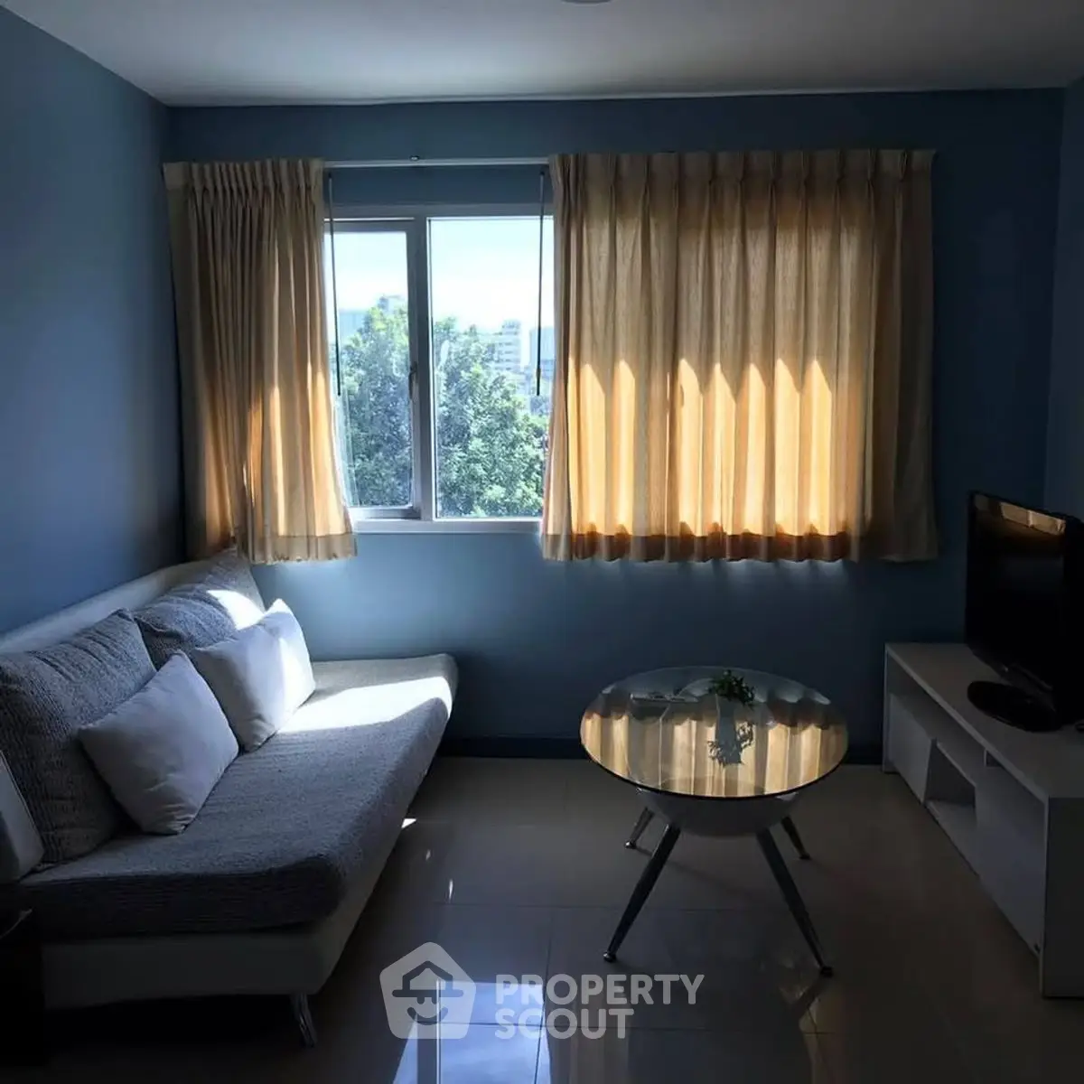 Cozy living room with natural light and modern furnishings.