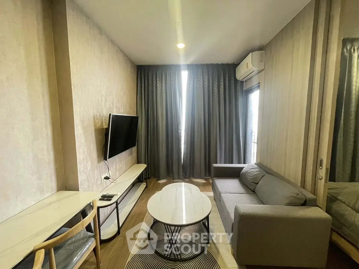 Modern living room with sleek furniture and wall-mounted TV, perfect for cozy urban living.