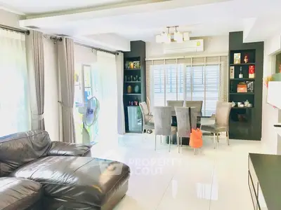 Spacious living room with modern decor and large windows for natural light.