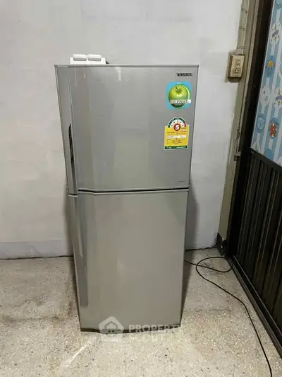 Modern silver refrigerator in a minimalist kitchen setting, perfect for contemporary homes.