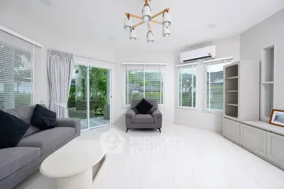 Spacious modern living room with large windows and elegant decor