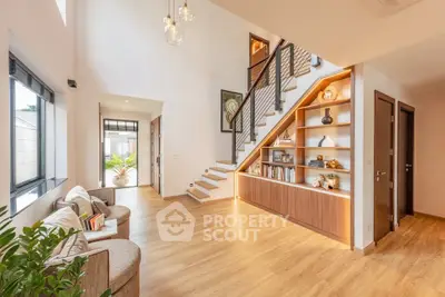 Spacious modern living room with elegant staircase and natural light