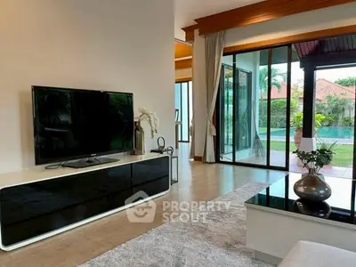 Spacious living room with modern decor and garden view