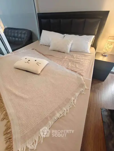 Cozy bedroom with stylish bed and soft lighting, perfect for relaxation.